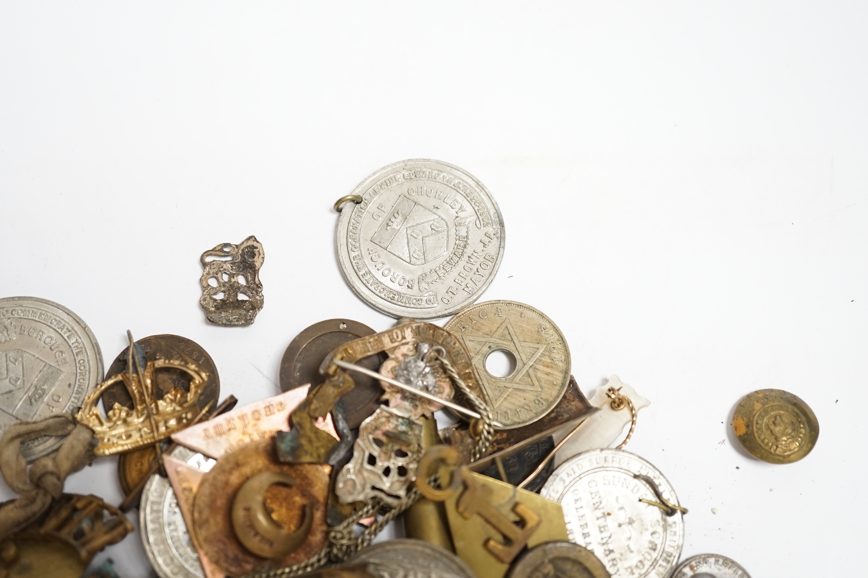 A quantity of military cap badges, etc.